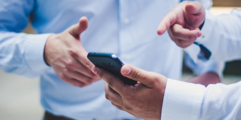 Two People Looking at Mobile Phone